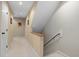 Hallway featuring a staircase with a wooden handrail and carpeted steps at 7917 Holly Springs Rd, Raleigh, NC 27606