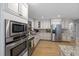 Well-appointed kitchen featuring stainless steel appliances, granite countertops, and custom cabinetry at 7917 Holly Springs Rd, Raleigh, NC 27606