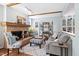 Cozy living room with a brick fireplace, wood flooring, and comfortable seating area for relaxation at 7917 Holly Springs Rd, Raleigh, NC 27606