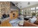 Open-concept living area with high ceilings, large windows, fireplace, and comfortable seating at 7917 Holly Springs Rd, Raleigh, NC 27606