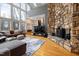 Living room with a stone fireplace, wood floors, comfortable seating, and lots of natural light at 7917 Holly Springs Rd, Raleigh, NC 27606