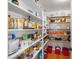 Walk-in pantry with abundant shelving for ample storage of food, cooking supplies, and other household items at 7917 Holly Springs Rd, Raleigh, NC 27606