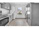 Well-lit kitchen with stainless steel appliances and neutral cabinets at 810 Cox Ave, Durham, NC 27701