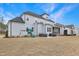Expansive backyard featuring a hot tub, patio area, screened-in porch, and a swing set under a blue sky at 83 Inspiration Way, Fuquay Varina, NC 27526
