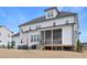 A spacious backyard with a hot tub, patio, screened-in porch, and play set under a bright blue sky at 83 Inspiration Way, Fuquay Varina, NC 27526