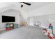 Upstairs bonus room featuring a TV and additional play area at 83 Inspiration Way, Fuquay Varina, NC 27526