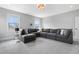 Bright bonus room featuring a large sectional sofa, neutral walls, and plush carpeting at 83 Inspiration Way, Fuquay Varina, NC 27526