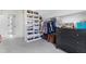 Custom walk-in closet featuring shelves, hanging rods, and a dresser at 83 Inspiration Way, Fuquay Varina, NC 27526