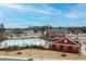 View of the community pool and amenities, set against a backdrop of neighborhood homes and a partly cloudy sky at 83 Inspiration Way, Fuquay Varina, NC 27526