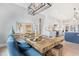 Dining area with rustic table, modern chairs and bench, with a view to the open kitchen at 83 Inspiration Way, Fuquay Varina, NC 27526