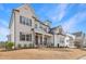A charming two-story home with a brick exterior and well-manicured landscaping under a blue sky at 83 Inspiration Way, Fuquay Varina, NC 27526