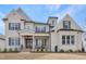 Charming two-story home features a welcoming front porch and meticulously maintained landscaping at 83 Inspiration Way, Fuquay Varina, NC 27526