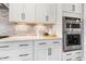 Kitchen area featuring a double oven, quartz countertops, modern cabinets, and tiled backsplash at 83 Inspiration Way, Fuquay Varina, NC 27526