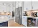 Bright kitchen with stainless steel refrigerator and appliance garage adjacent to the kitchen island at 83 Inspiration Way, Fuquay Varina, NC 27526