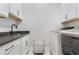 Practical laundry room featuring white cabinetry, a sink, and modern washer and dryer units at 83 Inspiration Way, Fuquay Varina, NC 27526
