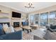 Elegant living room with a stone fireplace and sliding glass doors, leading to an outdoor patio at 83 Inspiration Way, Fuquay Varina, NC 27526