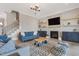 Cozy living room with a stone fireplace, built-in shelving, and comfortable seating arrangements at 83 Inspiration Way, Fuquay Varina, NC 27526