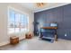 Office with navy blue paneled accent wall and lift desk overlooking exterior at 83 Inspiration Way, Fuquay Varina, NC 27526