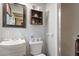 Modest bathroom featuring a vanity sink, toilet and shower at 911 Williams Rd, Raleigh, NC 27610