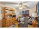 Bedroom featuring wood floors, ceiling fan, and a vintage-style dresser with mirror at 911 Williams Rd, Raleigh, NC 27610