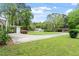 Wide angle view of a single story home featuring a long driveway and lush green lawn at 911 Williams Rd, Raleigh, NC 27610