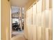 Hallway with decorative white curtain leads into a dining area with dark chairs at 911 Williams Rd, Raleigh, NC 27610