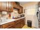 Functional kitchen features wood cabinets, double sinks, and ample counter space at 911 Williams Rd, Raleigh, NC 27610