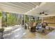Spacious covered back patio with comfortable seating, a ceiling fan, and a view of the backyard at 105 Blanchard St, Fuquay Varina, NC 27526