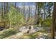 Serene backyard with a firepit, playground, and mature trees creating a private oasis at 105 Blanchard St, Fuquay Varina, NC 27526
