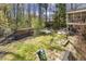 Lush backyard offering a wood storage, patio, and ample space for outdoor activities at 105 Blanchard St, Fuquay Varina, NC 27526