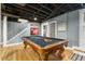 Finished basement featuring a pool table under an exposed ceiling, next to the stairs at 105 Blanchard St, Fuquay Varina, NC 27526