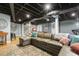 Cozy finished basement with comfortable seating, exposed ceiling, and natural lighting at 105 Blanchard St, Fuquay Varina, NC 27526