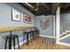 Finished basement with a bar area with modern stools perfect for gathering or enjoying a casual meal at 105 Blanchard St, Fuquay Varina, NC 27526