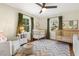 Cozy bedroom with two cribs, soft lighting, a comfortable armchair, and wooden floors at 105 Blanchard St, Fuquay Varina, NC 27526