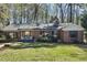 Charming brick home featuring dark shutters, black framed windows and a well maintained lawn at 105 Blanchard St, Fuquay Varina, NC 27526