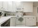 Cozy kitchen featuring white cabinets, laminate countertops, and standard appliances at 105 Blanchard St, Fuquay Varina, NC 27526