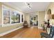 Living room featuring large windows, hardwood flooring, and decorative trim at 105 Blanchard St, Fuquay Varina, NC 27526