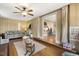 Bright living room with hardwood floors, a ceiling fan, and an open doorway to the next room at 105 Blanchard St, Fuquay Varina, NC 27526