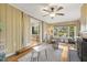 Inviting living room with a play area, a ceiling fan, hardwood floors, and large windows at 105 Blanchard St, Fuquay Varina, NC 27526