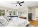 Comfortable bedroom with a large bed, a dresser, and a view of the outdoors through the windows at 105 Blanchard St, Fuquay Varina, NC 27526