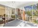 Bright sunroom with patterned floors, views to the backyard, and access to the dining area at 105 Blanchard St, Fuquay Varina, NC 27526
