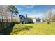 Spacious backyard featuring a wooden fence, lawn, and a playground with a slide and climbing structure at 105 Cherry Grove Dr, Cary, NC 27519