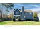 Back exterior showcasing a spacious yard and deck, set against a beautiful blue home at 105 Cherry Grove Dr, Cary, NC 27519