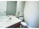 Powder room features a white vanity and toilet, with a decorative mirror and fixtures at 105 Cherry Grove Dr, Cary, NC 27519