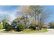 Two story gray house on a corner lot with mature trees and a landscaped yard at 105 Cherry Grove Dr, Cary, NC 27519