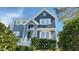 Two story home with gray siding and white trim with a garden in front and visible house number at 105 Cherry Grove Dr, Cary, NC 27519