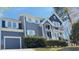 Two-story gray home with a detached garage, white trim, and landscaped yard at 105 Cherry Grove Dr, Cary, NC 27519