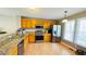 Bright kitchen with stainless steel appliances, granite countertops, and light wood cabinets at 105 Cherry Grove Dr, Cary, NC 27519