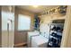 This laundry room features a window, two washers, and shelving for storage and organization at 105 Cherry Grove Dr, Cary, NC 27519