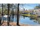 Scenic community pond view with trees and the reflection of a white clubhouse at 105 Cherry Grove Dr, Cary, NC 27519